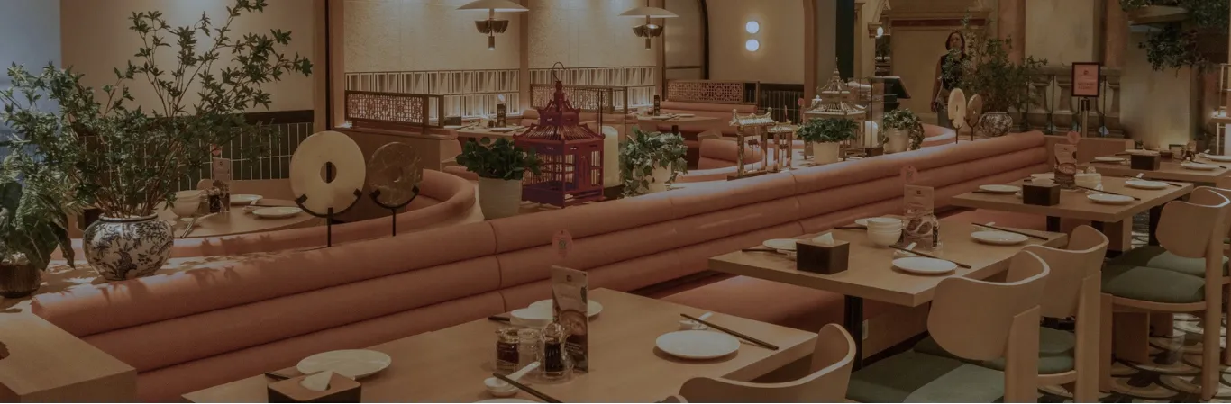 Crystal Jade restaurant interior with dining tables and pink banquette seating