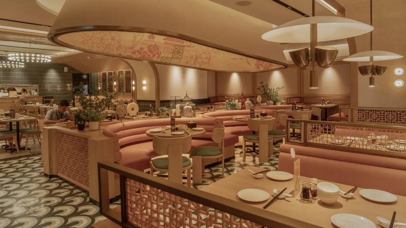 Warm restaurant dining room with curved banquette seating completed by PT Dwitama Jaya Perkasa