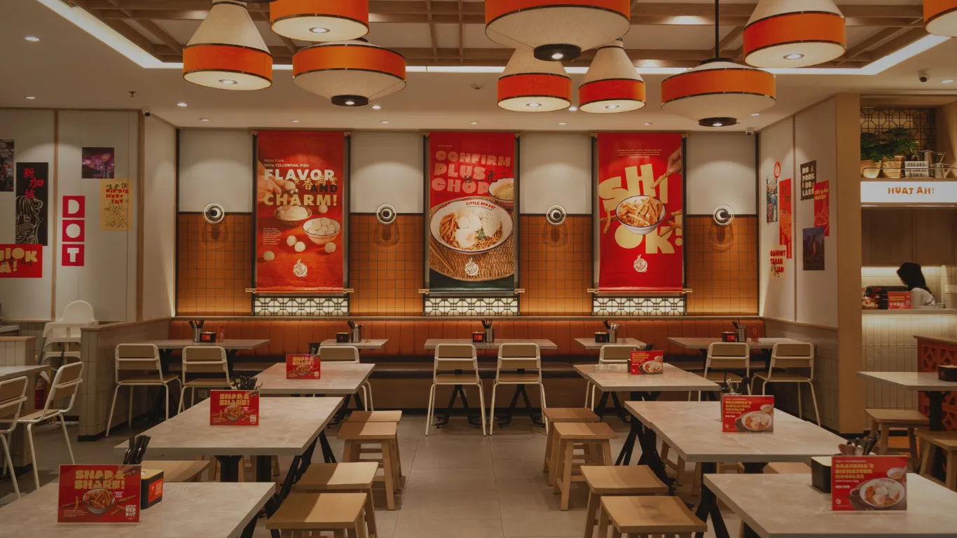 Little Red Dot restaurant dining room with red wall banners and pendant lights
